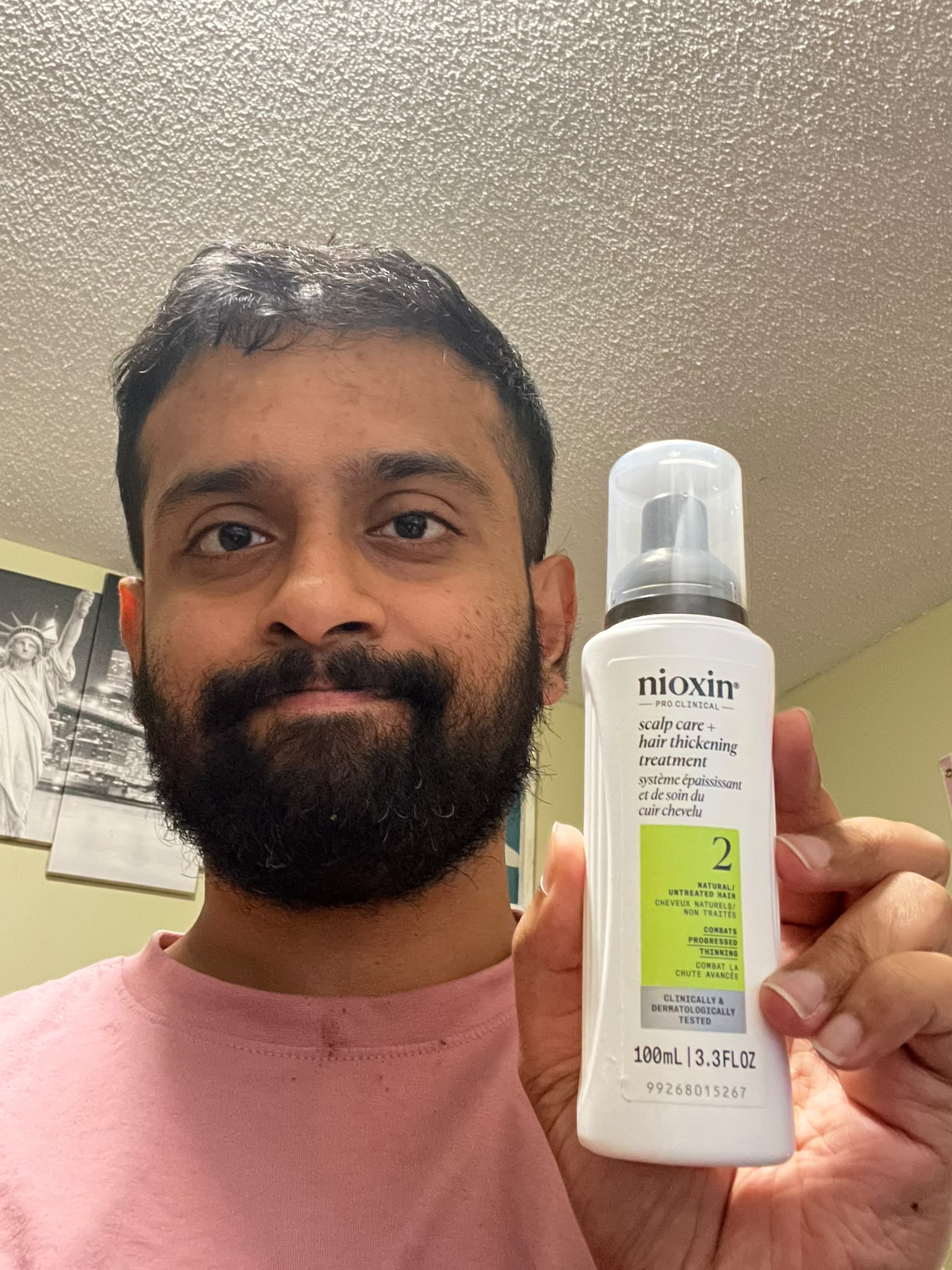Me holding Nioxin hair care treatment